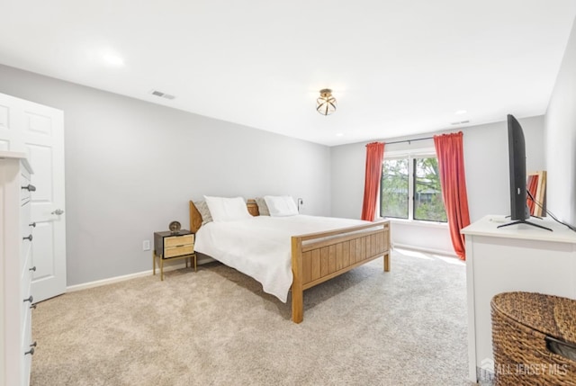 bedroom featuring baseboards, light carpet, recessed lighting, and visible vents