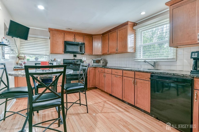 14 Bradford Rd, East Brunswick, NJ 08816 - kitchen featuring black appliances, light wood finished floors, a sink, decorative backsplash, and recessed lighting