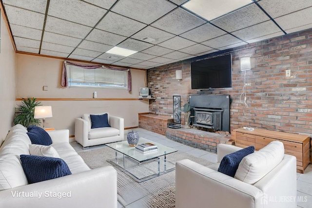 14 Bradford Rd, East Brunswick, NJ 08816 - living room with baseboards, brick wall, a drop ceiling, and a wood stove
