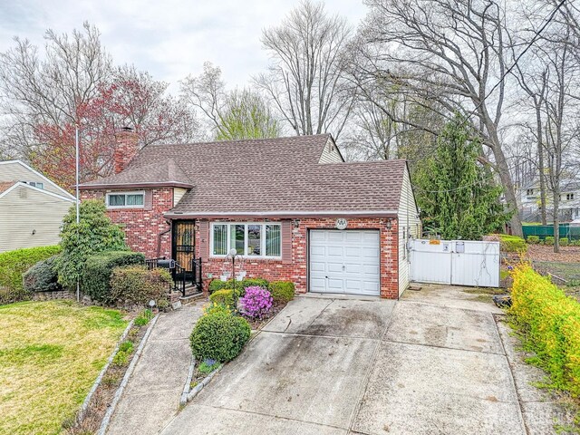 14 Bradford Rd, East Brunswick, NJ 08816 - view of front of home with brick siding, an attached garage, concrete driveway, a chimney, and roof with shingles