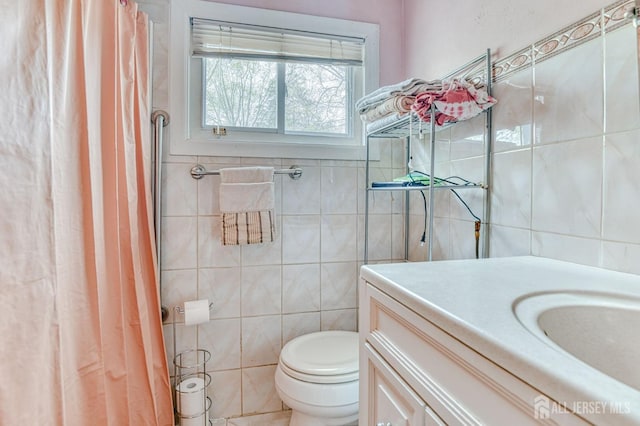 14 Bradford Rd, East Brunswick, NJ 08816 - bathroom with tile walls, toilet, vanity, and curtained shower