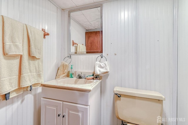 14 Bradford Rd, East Brunswick, NJ 08816 - half bathroom featuring vanity, toilet, and wooden walls