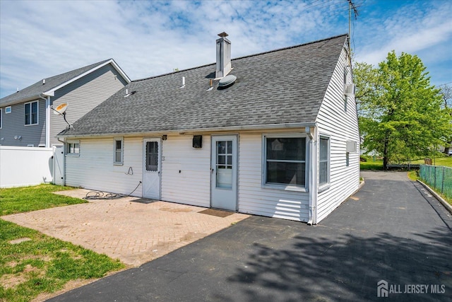 137 Grand Ave, Iselin, NJ 08830 - rear view of house with a shingled roof, a patio, and a chimney