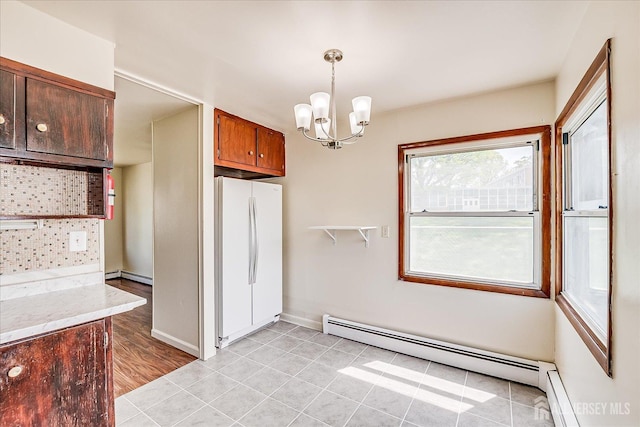 137 Grand Ave, Iselin, NJ 08830 - kitchen featuring freestanding refrigerator, a baseboard heating unit, a chandelier, and pendant lighting