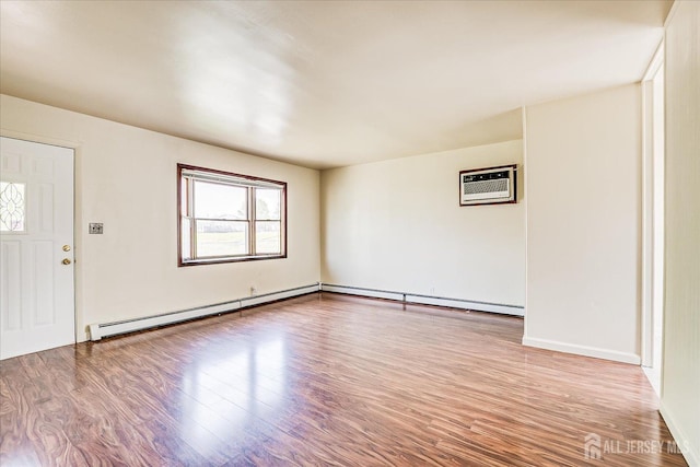 137 Grand Ave, Iselin, NJ 08830 - unfurnished room with a baseboard heating unit, a wall mounted air conditioner, and wood finished floors