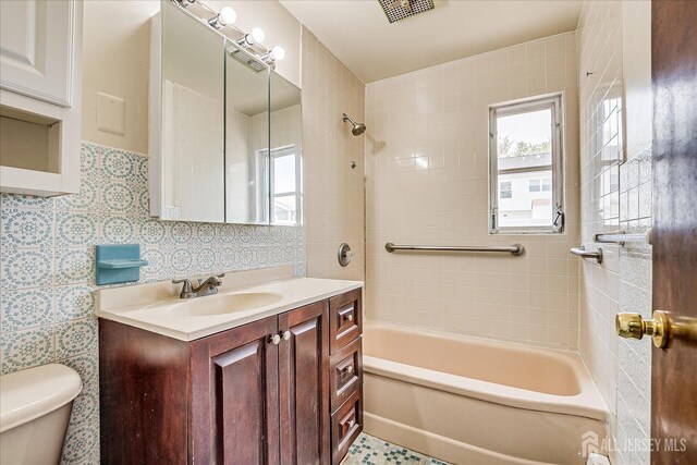 137 Grand Ave, Iselin, NJ 08830 - bathroom with plenty of natural light, toilet, vanity, and bathing tub / shower combination