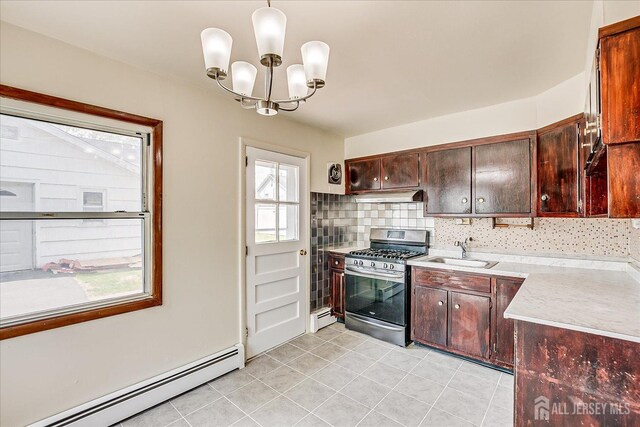 137 Grand Ave, Iselin, NJ 08830 - kitchen featuring stainless steel gas range, baseboard heating, a sink, a chandelier, and pendant lighting