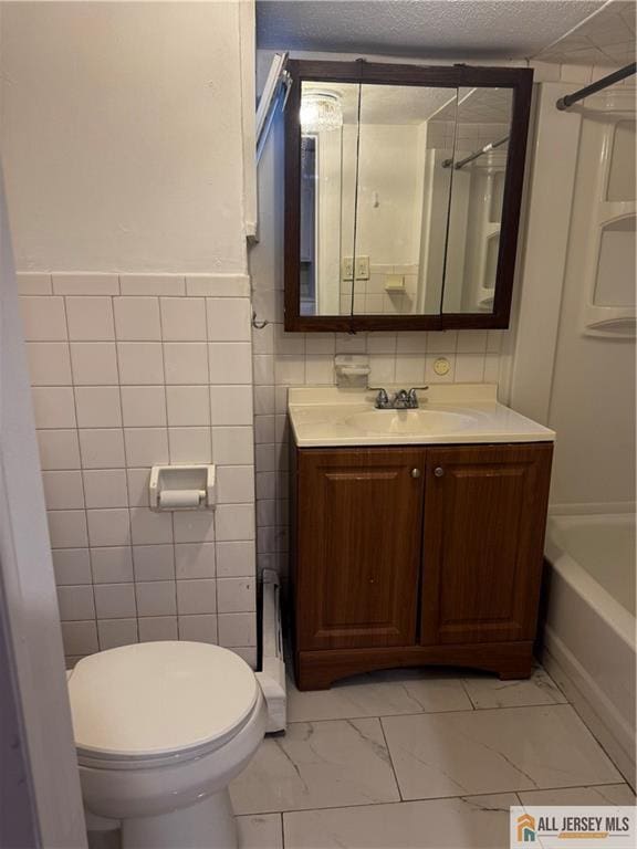 280 Shoreland Cir S, Amboy, NJ 08879 - bathroom with vanity, marble look tiles, tile walls, a textured ceiling, and  shower combination