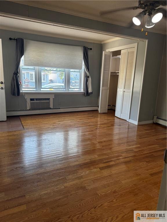 280 Shoreland Cir S, Amboy, NJ 08879 - unfurnished bedroom with ornamental molding, a baseboard heating unit, wood finished floors, and ceiling fan