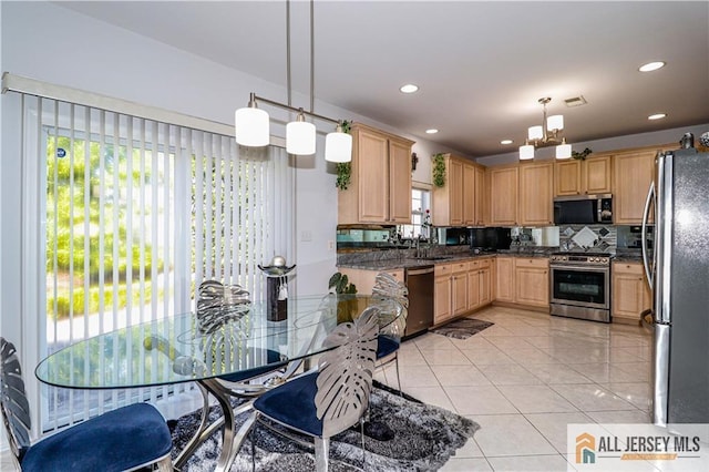 kitchen with stainless steel appliances, light brown cabinets, light tile patterned floors, pendant lighting, and decorative backsplash