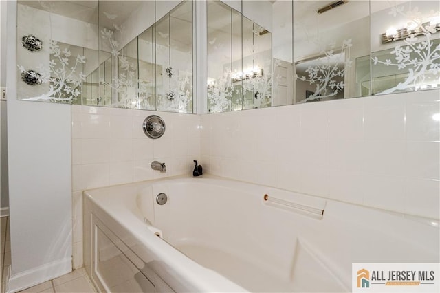 bathroom featuring a tile shower, a bath, and tile patterned flooring