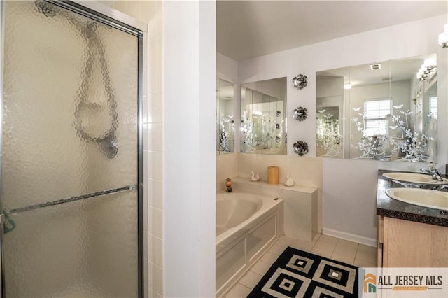 full bath with a bath, a shower stall, tile patterned floors, and vanity