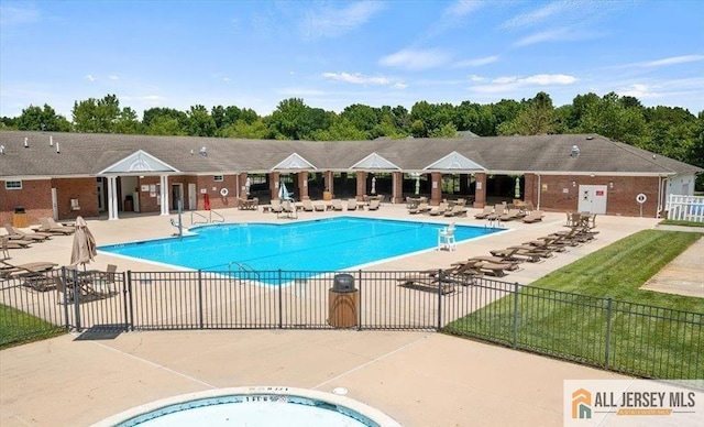 pool featuring fence and a patio area