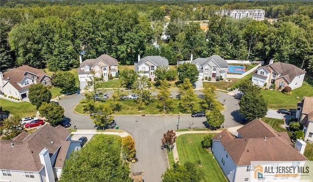 bird's eye view featuring a forest view and a residential view