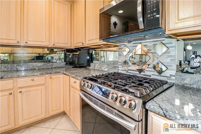 kitchen featuring light tile patterned floors, light brown cabinetry, backsplash, and appliances with stainless steel finishes
