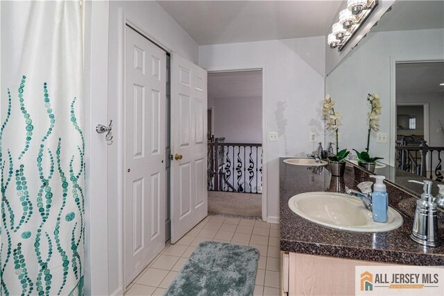 full bath with tile patterned floors, a sink, and double vanity