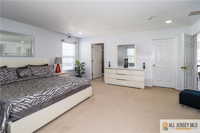 bedroom featuring light carpet, visible vents, and recessed lighting