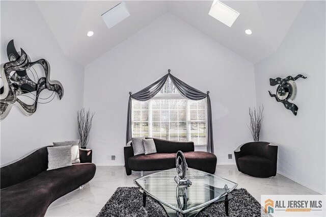 living room featuring marble finish floor, lofted ceiling with skylight, and recessed lighting