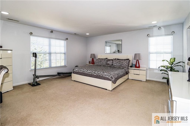 bedroom featuring recessed lighting, light carpet, visible vents, and baseboards