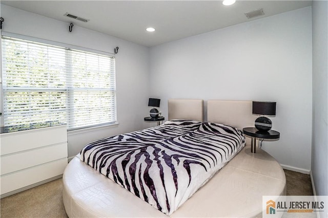 carpeted bedroom featuring baseboards, visible vents, and recessed lighting