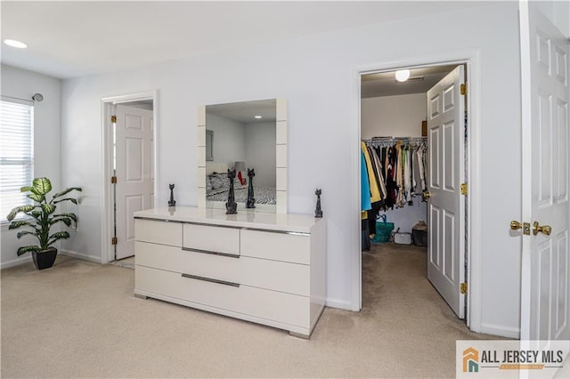 spacious closet featuring light colored carpet