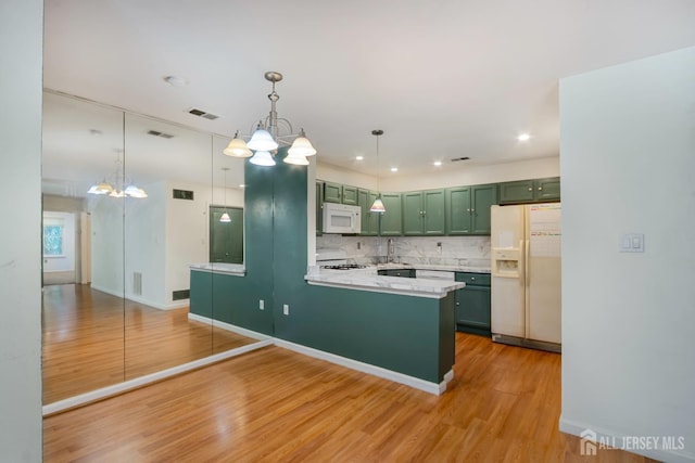 224 Pennsylvania Way N, Brunswick, NJ 08902 - kitchen featuring white appliances, green cabinetry, a chandelier, light countertops, and tasteful backsplash