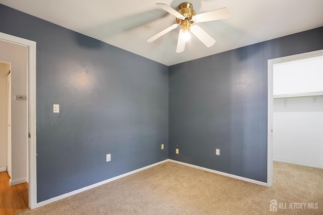 224 Pennsylvania Way N, Brunswick, NJ 08902 - unfurnished bedroom featuring carpet flooring, a ceiling fan, a closet, and a walk in closet