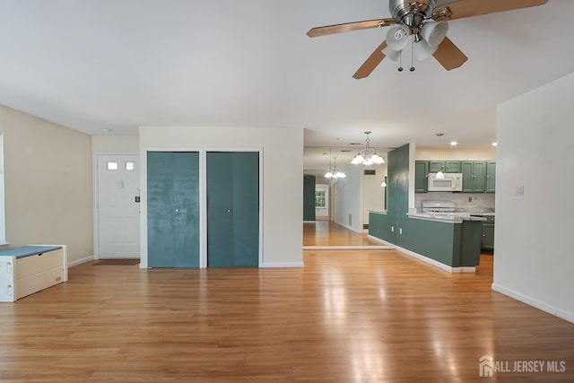 224 Pennsylvania Way N, Brunswick, NJ 08902 - unfurnished living room featuring ceiling fan, a chandelier, and light wood-style floors