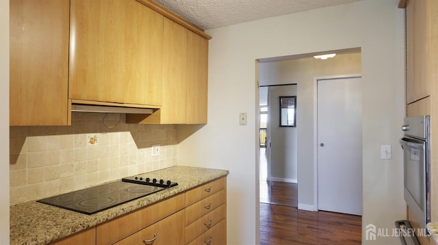 30 S Adelaide Ave Unit 7H, Highland Park, NJ 08904 - kitchen featuring black electric cooktop, tasteful backsplash, dark wood-style floors, light stone countertops, and extractor fan