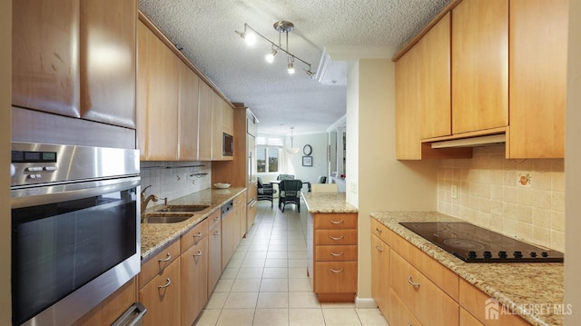 30 S Adelaide Ave Unit 7H, Highland Park, NJ 08904 - kitchen with stainless steel oven, black electric stovetop, a textured ceiling, light tile patterned floors, and decorative backsplash