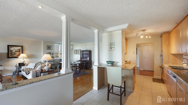 30 S Adelaide Ave Unit 7H, Highland Park, NJ 08904 - kitchen with ornate columns, a textured ceiling, light tile patterned floors, light stone counters, and ornamental molding