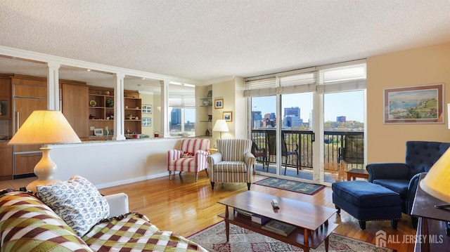 30 S Adelaide Ave Unit 7H, Highland Park, NJ 08904 - living room featuring a textured ceiling, plenty of natural light, a skyline view, and wood finished floors