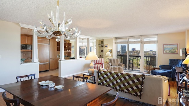 30 S Adelaide Ave Unit 7H, Highland Park, NJ 08904 - dining room featuring a chandelier, a textured ceiling, crown molding, and light wood-style floors