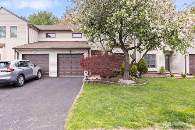 265 Plum Dr, Marlboro, NJ 07746 - view of front of house with asphalt driveway, a front lawn, roof with shingles, and a garage