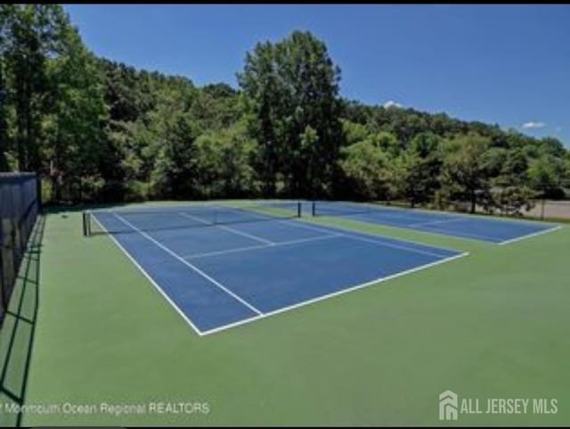 265 Plum Dr, Marlboro, NJ 07746 - view of tennis court featuring community basketball court and a forest view