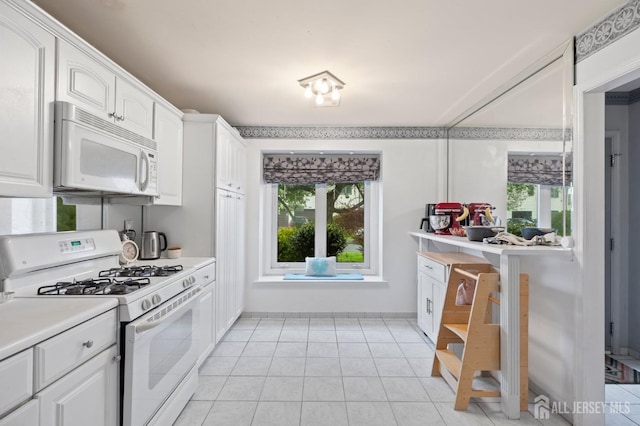 265 Plum Dr, Marlboro, NJ 07746 - kitchen featuring white appliances, white cabinets, light countertops, and light tile patterned floors