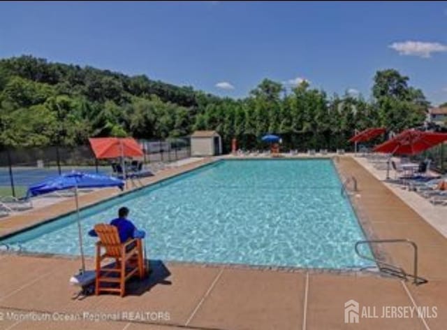 265 Plum Dr, Marlboro, NJ 07746 - community pool with a patio area