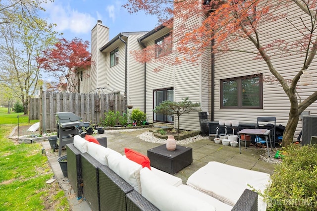 265 Plum Dr, Marlboro, NJ 07746 - back of property with outdoor lounge area, a chimney, and a patio area