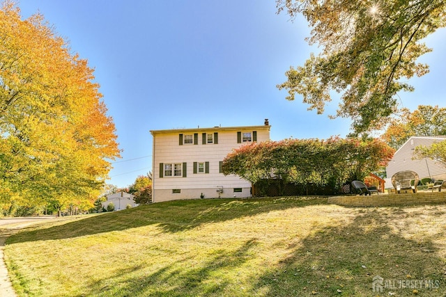 back of property featuring a lawn