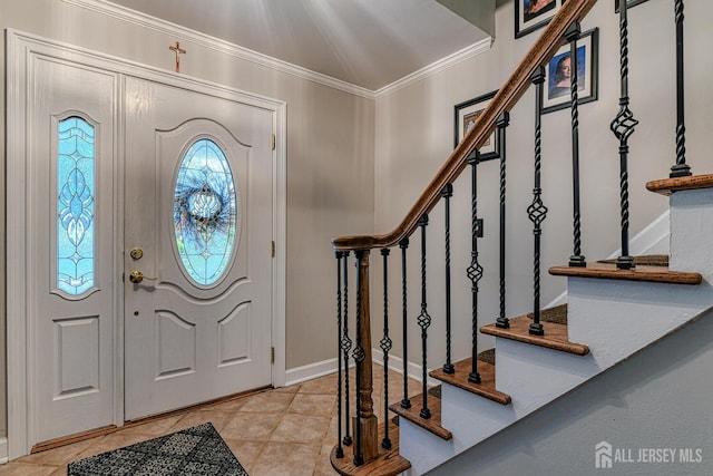 foyer entrance with crown molding and light tile patterned floors