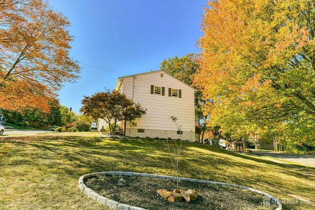 view of side of property with a yard