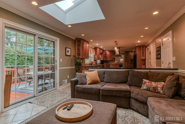 tiled living room featuring crown molding and a skylight