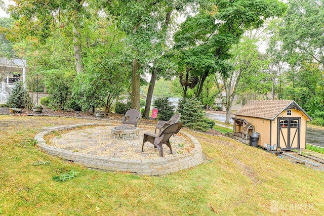 view of yard with a storage unit and an outdoor fire pit