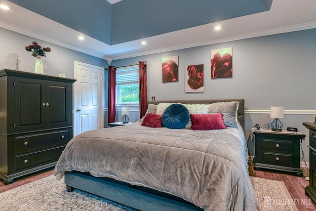 bedroom featuring wood-type flooring and crown molding