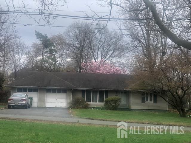 16 Stephenville Pkwy, Edison, NJ 08820 - ranch-style house with an attached garage, driveway, and a front lawn