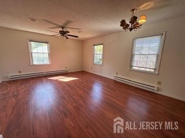 406 Oxford Ln Unit O, Monroe, NJ 08831 - spare room featuring a baseboard heating unit, plenty of natural light, a chandelier, and a textured ceiling