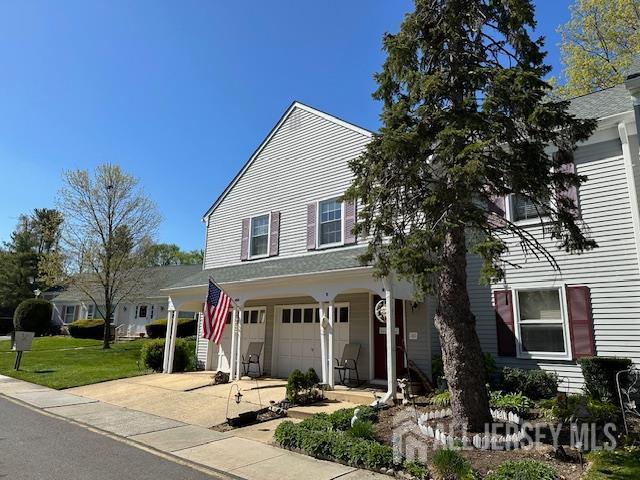 406 Oxford Ln Unit O, Monroe, NJ 08831 - view of front facade featuring concrete driveway, an attached garage, and a front lawn