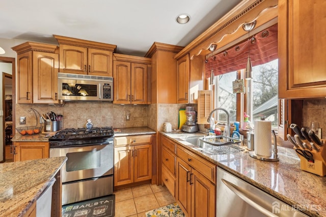 6 Claremont Ave, Colonia, NJ 07067 - kitchen featuring stainless steel appliances, a sink, light stone countertops, brown cabinets, and recessed lighting