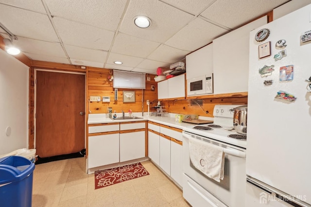 6 Claremont Ave, Colonia, NJ 07067 - kitchen featuring white appliances, a paneled ceiling, white cabinets, light countertops, and a sink