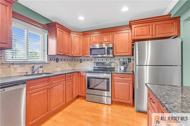 2507 Balmoral Ct, Hillsborough, NJ 08844 - kitchen featuring appliances with stainless steel finishes, light wood-style flooring, tasteful backsplash, dark stone countertops, and recessed lighting